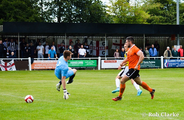 Ben slotting the ball under the goalkeeper...